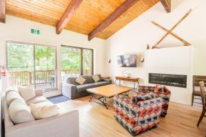 a living room with a couch and a table at Blue View Chalets in Blue Mountains