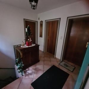 a room with a hallway with two doors and a christmas tree at Haus Nummer 7 in Manderscheid