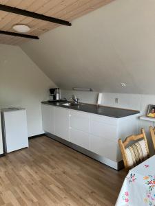 a kitchen with a sink and a counter at Lejlighed i Soldalen in Sindal