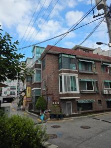 an old brick building on a city street at Banghwa Space 5 min to Banghwa Stn, Near Gimpo Airport, Magok & COEX in Seoul