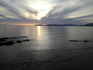 a sunset over a large body of water at Brezza marina in Alghero