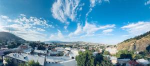 a view of a city under a cloudy sky at Hotel All Time in Tbilisi City