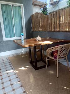 a wooden table in a room with a chair at Starlight Bungalows - 3 Mins Walk To Beach in Ko Lanta Yai