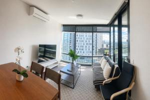 a living room with a couch and a table at Stadium View Retreat at Olympic Park in Sydney
