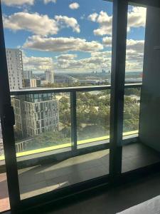 a view of a city from a window in a building at Stadium View Retreat at Olympic Park in Sydney