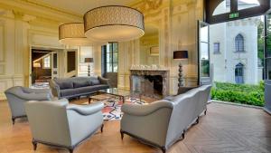 a living room with couches and a fireplace at Château de Candes - Art & Spa in Candes-Saint-Martin