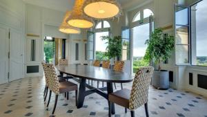 a large dining room with a table and chairs at Château de Candes - Art & Spa in Candes-Saint-Martin