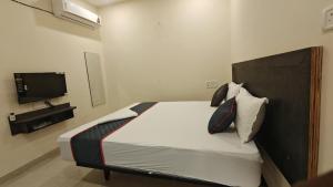 a bedroom with a bed and a television in it at Melody Stays Inn in Chennai
