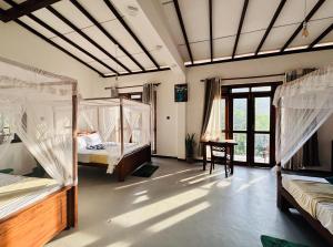 a room with four bunk beds and a window at Ella Scenic Heights in Ella