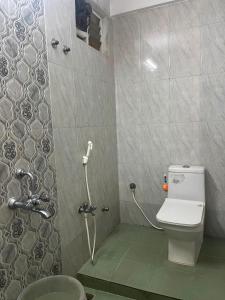 a bathroom with a toilet and a shower at Serenity Sunrise Beach Resort in Pondicherry +38 photos