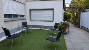 a group of chairs on a patio with grass at Koblenz Corner Rooms in Koblenz
