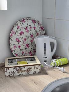 a kitchen counter with a tea kettle and a plate at Alfi apartments 1 in Belgrade