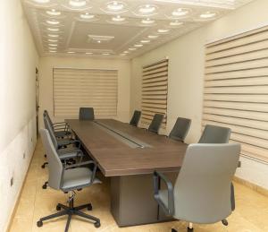 a conference room with a large table and chairs at Maya Lodge in Accra