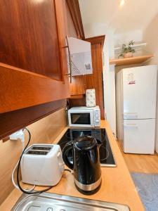 a kitchen with a stove with a tea kettle on it at Studio Bulle de Rêve à deux pas du Port in Nice +19 photos