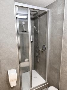 a shower with a glass door in a bathroom at Gasthof Alpenblick in Tobadill +79 photos