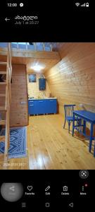 a kitchen and dining room with a blue table at Akhateli in Ruispiri