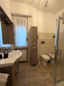 a bathroom with a sink and a toilet at Zuly House in Savona +34 photos
