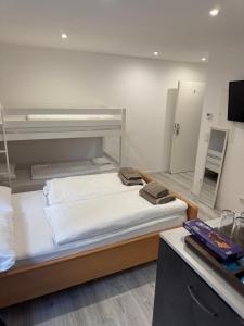 a bedroom with two bunk beds and a mirror at Ferienwohnung Manolya in Günzburg