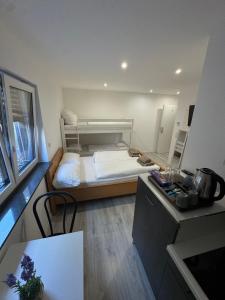 a small room with a bed and a table at Ferienwohnung Manolya in Günzburg