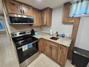 a kitchen with wooden cabinets and a stove top oven at The Cottonwood Den in Laramie