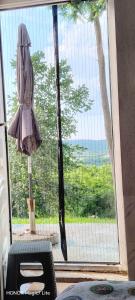 a window with an umbrella and a view of the ocean at Kosmaj - Sopot in Sopot