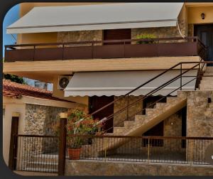 a building with a staircase and a balcony at AGGELIKI STUDIOS in Agios Georgios