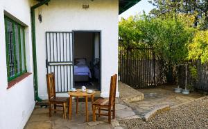 a small patio with a table and two chairs at Joe's Place Self-Catering in Windhoek