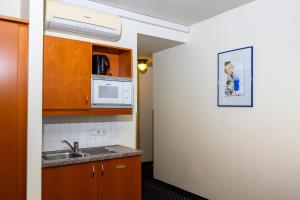 a kitchen with a sink and a microwave at Suite Hotel 900m zur Oper in Vienna +37 photos