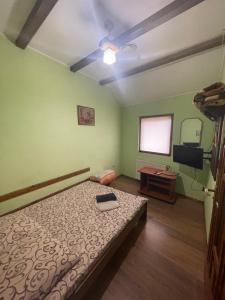 a bedroom with a bed and a television in it at Міраж in Uzhhorod +9 photos