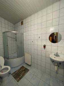 a bathroom with a shower and a toilet and a sink at Міраж in Uzhhorod