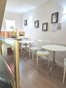 a restaurant with tables and chairs in a room at Hotel Schtak in Cannes