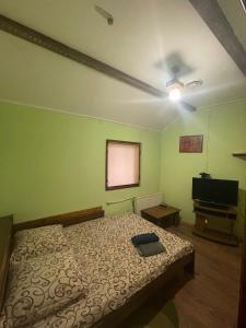 a bedroom with a bed and a flat screen tv at Міраж in Uzhhorod
