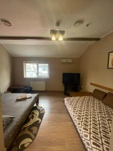 a bedroom with a bed and a tv in it at Міраж in Uzhhorod