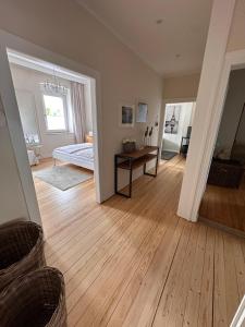 a living room with a wooden floor and a bedroom at Haus 1a in Lauterecken +2 photos