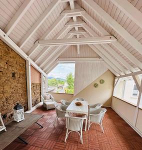 a living room with a table and chairs at Haus 1a in Lauterecken