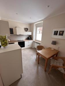 a kitchen with a table and a dining room at Haus 1a in Lauterecken