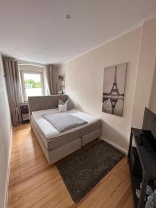 a bedroom with a bed and a picture of the eiffel tower at Haus 1a in Lauterecken