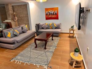 a living room with a couch and a table at Villa TaouBa in Ghazoua