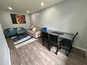 a living room with a table and a couch at Cute Highland Park(Upper-A-Unit) in Calgary