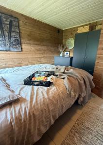 a bed with a tray of food on top of it at Karnes Lodge in Oksevik