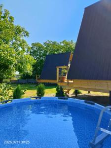 a swimming pool in front of a house at Akhateli in Ruispiri