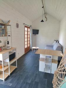 a room with a bed and a desk in a room at La tiny house in Bissières +2 photos