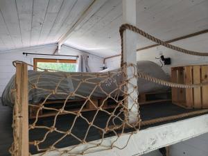 a bed in a room with a net at La tiny house in Bissières