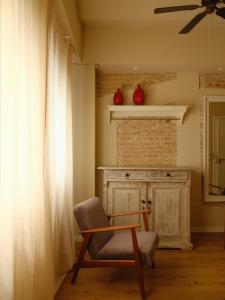 a living room with a chair and a fireplace at Casa Reina Cabanyal in Valencia +41 photos