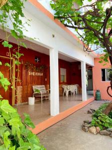 an outside view of a house with a table and chairs at Shekináh in Villa Cura Brochero