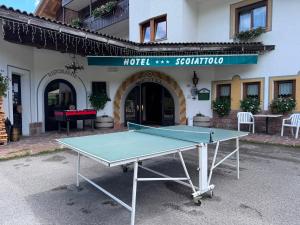 a ping pong table in front of a building at Albergo Scoiattolo Dolomites Experience in Falcade +86 photos