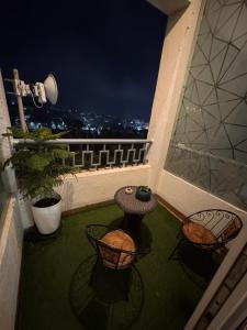 a balcony with a view of the city at night at Bs BnB Luxury Studio Apartment in Dehradun