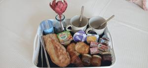 a plastic container filled with breakfast foods and drinks at L'Arcadia Chambres d'hôtes près de Vaison la Romaine et Mont Ventoux à Crestet in Crestet