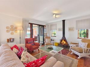 a living room with a couch and a fireplace at Eindelik in Simonʼs Town +42 photos
