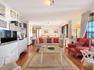 a living room with a couch and a table at Eindelik in Simonʼs Town
